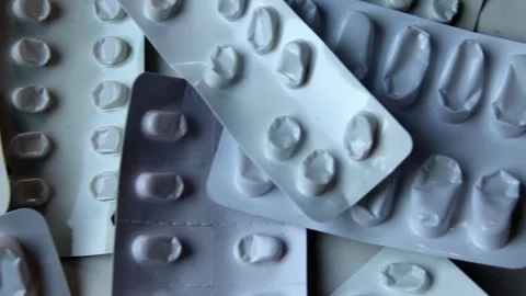 Many empty pill packages blisters of drug addicted people drug abusing Stock Footage 204475854