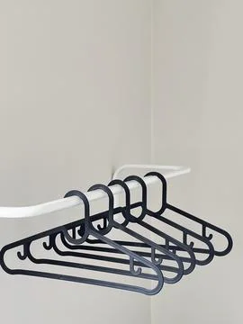 Many empty plastic clothes racks hang on the rail Stock Photos