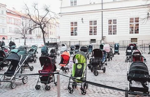 Many empty prams exhibited on town market square in Lviv, Ukraine Photos