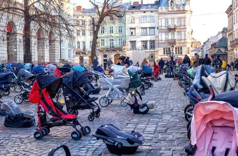 Many empty prams on market square symbolise children killed in war 스톡 사진