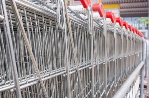 Many empty shopping carts in a row. Stock Photos