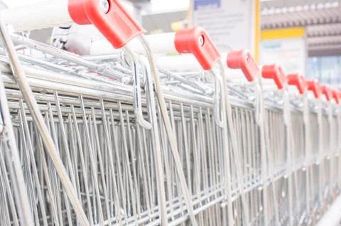 Many empty shopping carts in a row. Stock Photos