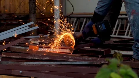 Many Fire Sparks Spreads When A Man Cuts Metal With An Angle Grinder In His Yard Stock Footage 328460647