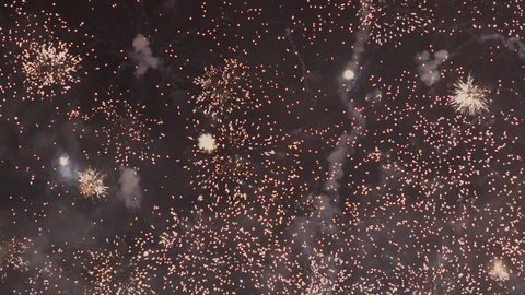 Many fireworks explode on screen, slowly building up before fading away Stock Footage