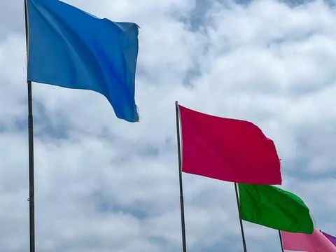 Many flags fluttering by the coast Stock Photos