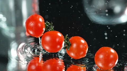 Many Fresh Raw Cherri Tomatoes Falling In Water At Black Background,Slow Motion Stock Footage 113103273