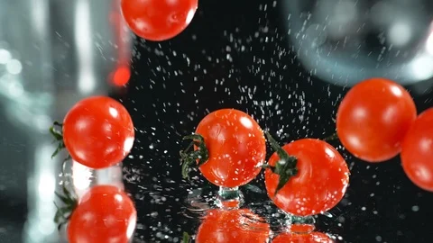 Many Fresh Raw Cherri Tomatoes Falling In Water At Black Background,Slow Motion Stock Footage 113103786