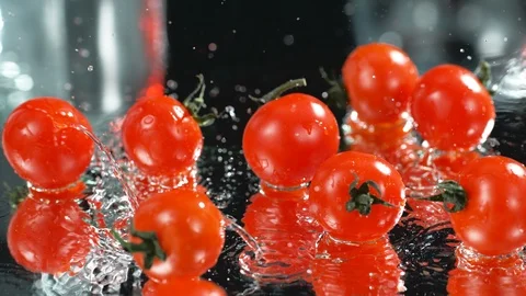 Many Fresh Raw Cherri Tomatoes Falling In Water At Black Background, Slow Motion Stock Footage 113103855