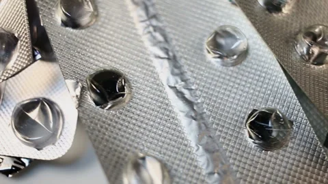 Many of the garbage rotates in the frame. Empty used cold-formed aluminium blist Stock Footage 145374396