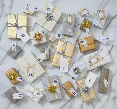 Many gift boxes with labels numbers for Advent calendar wrapped in glossy Stock Photos