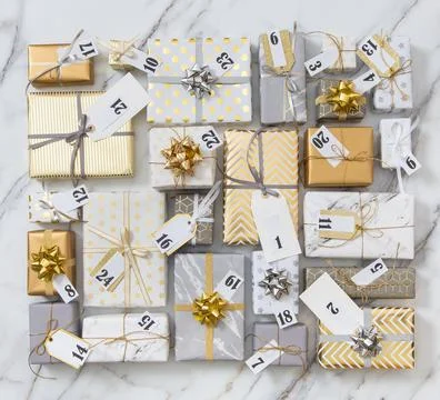 Many gift boxes with labels numbers for Advent calendar wrapped in glossy Stock Photos