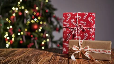 Many gift boxes wrapped in multi-colored paper on a wooden table Stock Photos