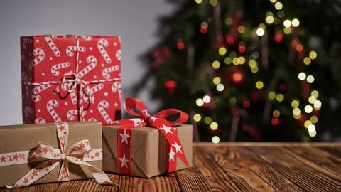 Many gift boxes wrapped in multi-colored paper on a wooden table Stock-Fotos