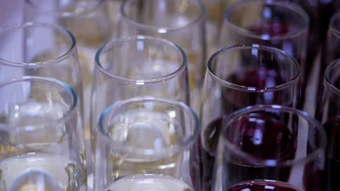 Many glasses with red and white wines. Top view. Slow motion. Stock Footage 127621099