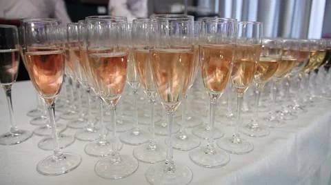 Many glasses of wine are on the table with wine bottle. Peolple drinks Stock Footage 52816144