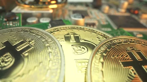 Many gold Bitcoins on the microcircuits in Macro shot. Microchip and digital Stock Footage 141377784