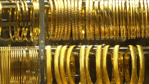 Many gold bracelets hanging in rows Stock-Footage 115783280
