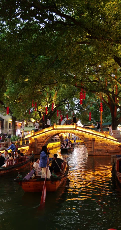 Many gondolas on small canals of Tangli ancient town at night, bright bridge Stock-Footage 327655285