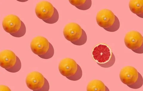 Many grapefruits seamless pattern on abstract pastel pink background Stock Photos