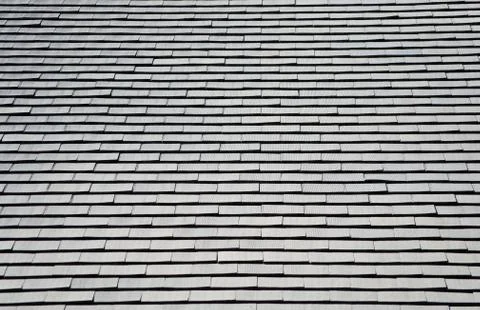 Many gray shingles on a gray rooftop Stock Photos