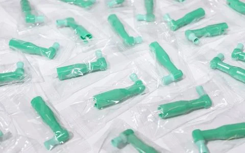 Many Green Disposable Prophy Angles with Brush, Ergonomic Shape on White Stock Photos