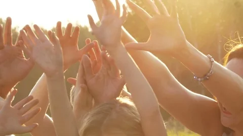 Many hands against the setting sun Stock Footage 82202979