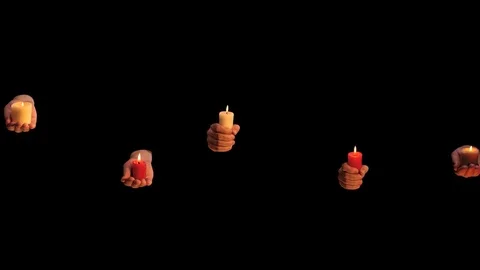 Many hands with burning candles approaching on black background Stock Footage 73256841
