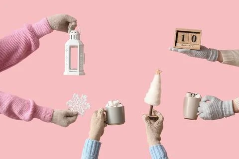 Many hands in different warm winter gloves with calendar, cups of cocoa and d Stock Photos
