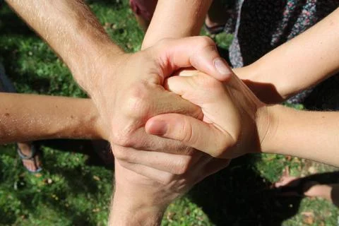 Many hands hold together Stock Photos