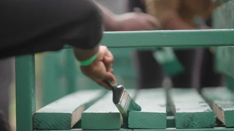 Many hands paint a park bench Stock Footage 263144447
