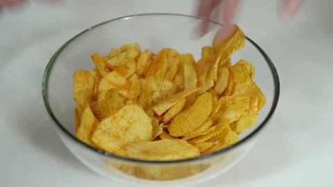Many hands take chips from the cup on the table Stock Footage 139640669