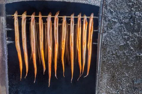 Many hanging eels are being smoked Stock Photos