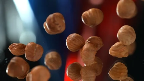 Many hazelnuts fall on the table on the background, Slow Motion, 4k, phantom Stock Footage 114980280