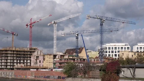 Many high tower cranes work on the construction of new buildings. Stock Footage 124323868