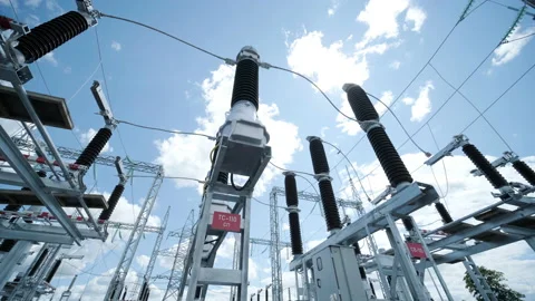 Many high voltage electrical insulators in power substation against blue sky Stock Footage 202155991