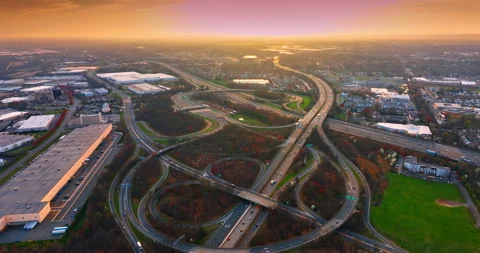 Many highways intertwine into the large intersection. Traffic at the outskirts Stock Footage 332737581