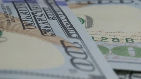 Many hundreds of American dollars on table slowly spinning close-up. High Stock Footage 306065163