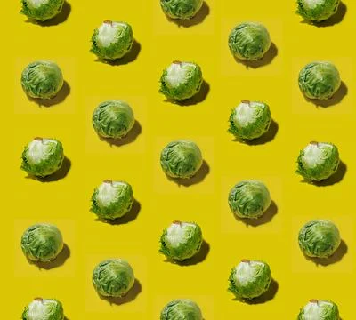 Many iceberg lettuce on a solid yellow background pattern Stock Photos