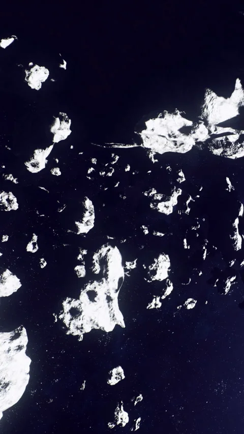 Many icebergs floating in dark ocean water seen from above at night Stock Footage 339954159