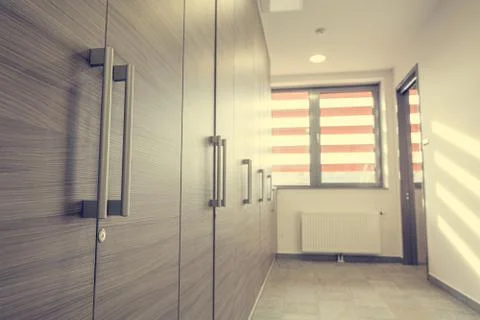 Many identical closets on a bright corridor. Stock Photos