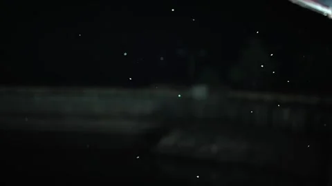 Many insects fly around the lamp at night, slow motion Stock Footage 330045673