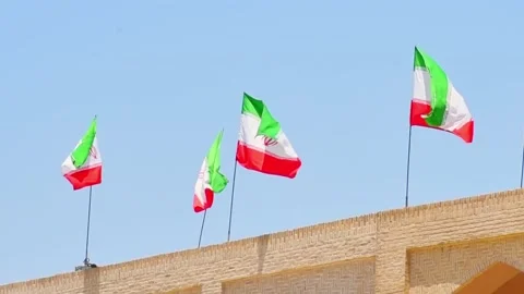 Many iranian flags wave in wind on rooftop of building Stock-Footage 229638743