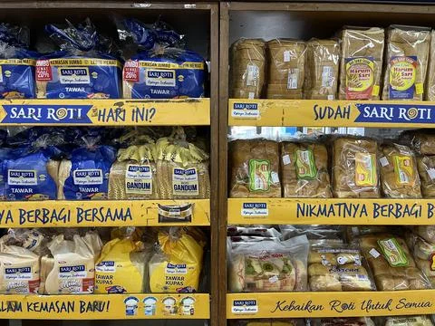 Many kinds of bread in plastic packaging for sale in a supermarket. Stock Photos
