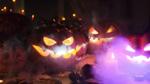 Many lanterns carved from pumpkins with flickering lights of various colors Stock Footage 252070868