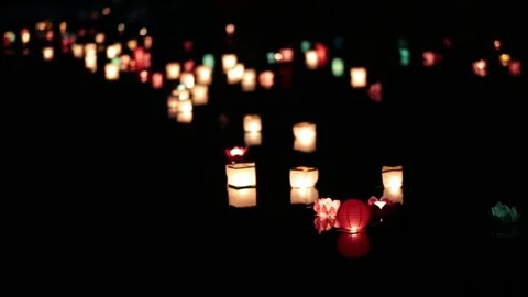 Many lanterns floating down the river at night. Video stock 77233068