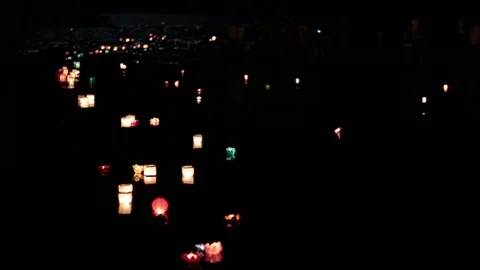 Many lanterns floating down the river at night. Sea waves on background. Stock-Footage 77233275