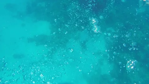 Many large bubbles in the azure sea water after scuba diving. Stock Footage 237021795