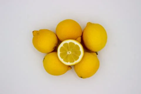 Many lemons and a half of a lemon isolated image on a white background Stock Photos