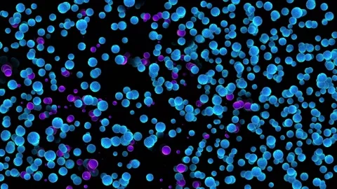 Many light blue balls rotate on a black background. Among them, pink appear Stock Footage 164521995