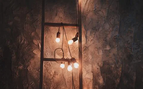 Many light bulbs in the loft interior Stock Photos